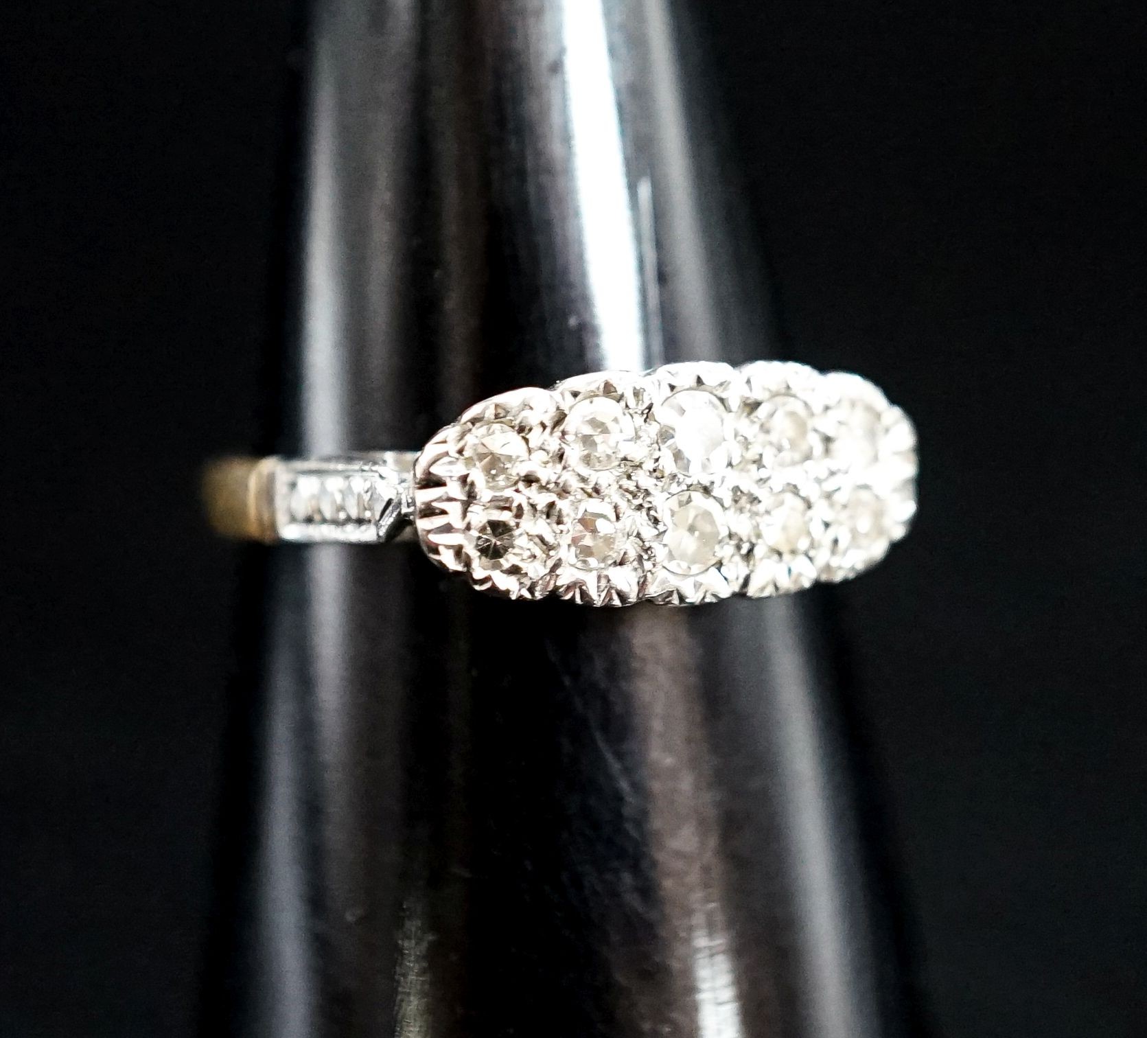 An 18ct & plat and two row diamond set cluster ring, size O, gross weight 2.7 grams.